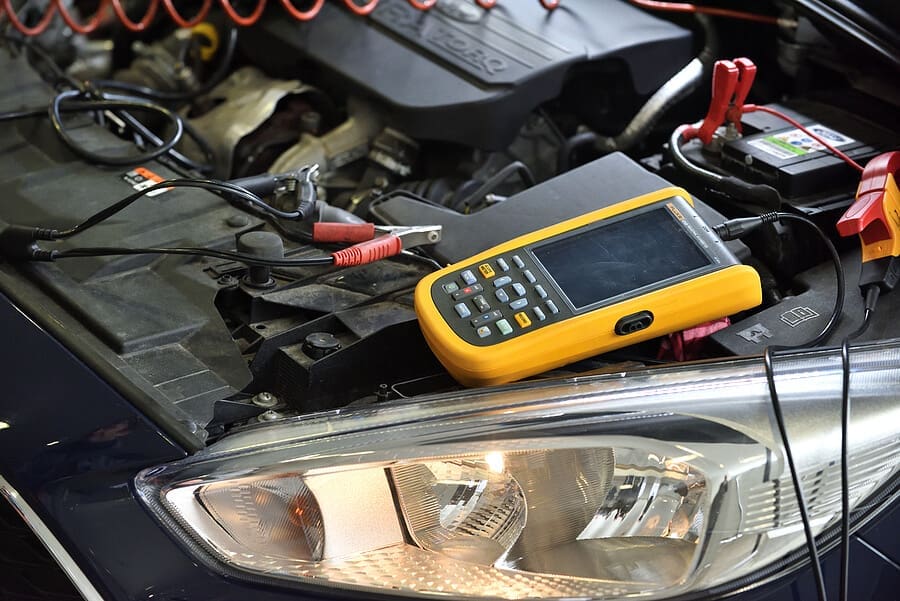 Diagnostics machine sitting under the hood of a car