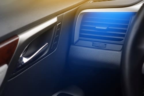Accelerate Auto Repair in Rowlett Tx A/C service and repair;image of a car air conditioning vent near steering wheel with blue haze to make it look like cool air blowing out