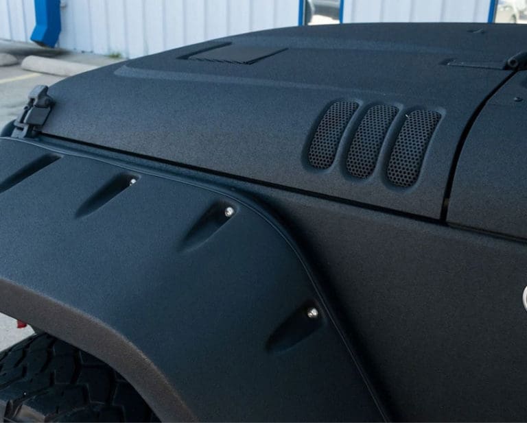 Close-up of jeep exterior; kevlar & raptor spray-on liners