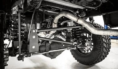 image of underneath a brand new lift kit showing exhaust on offroad vehicle at Accelerate Auto Repair in Rowlett Tx
