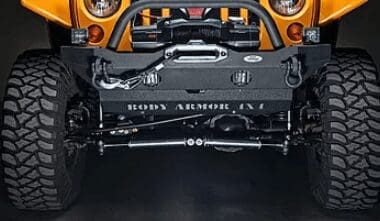 An orange jeep wrangler with it's brand new lift kit put on at Accelerate Auto Repair in Rowlett Tx offroad installs and modifications department