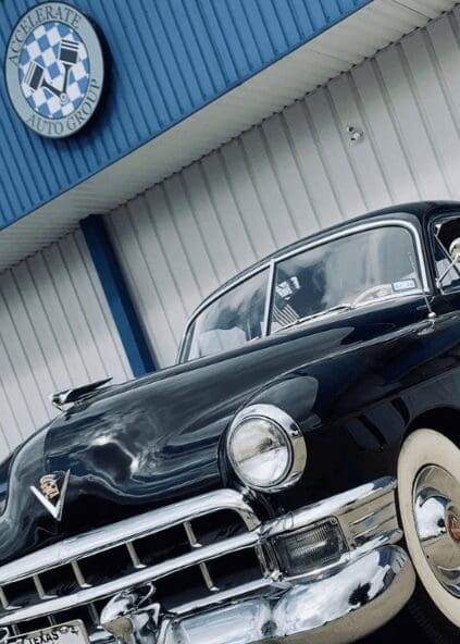Close-up of the hood of a classic car, parked at Accelerate Auto Repair